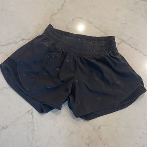 Lululemon black athletic shorts with the lulu logo.
